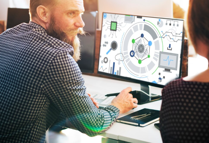 Person analyzing data on computer screen.