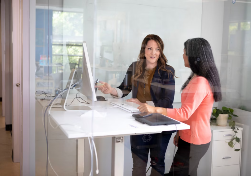 Two women collaborating at a desk.