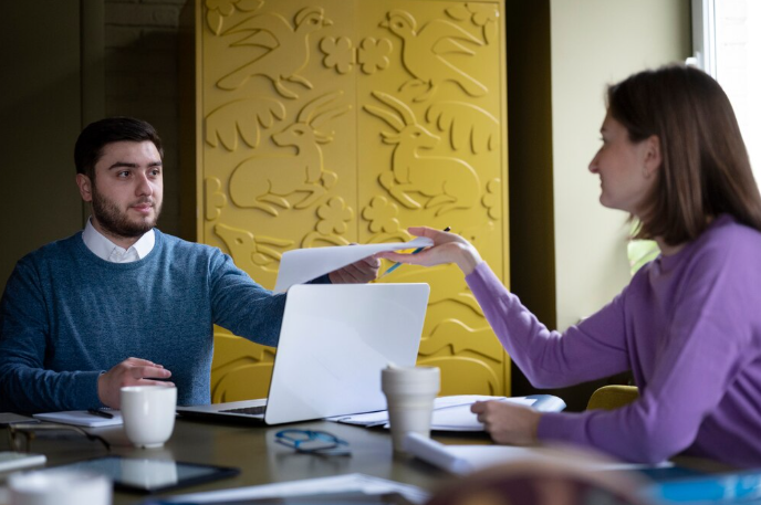 Business meeting with document exchange.