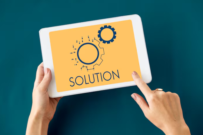 Person holding tablet displaying word solution with gear icons.