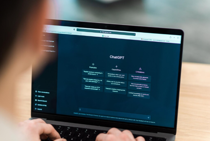 Person using ChatGPT interface on laptop for AI-powered assistance.