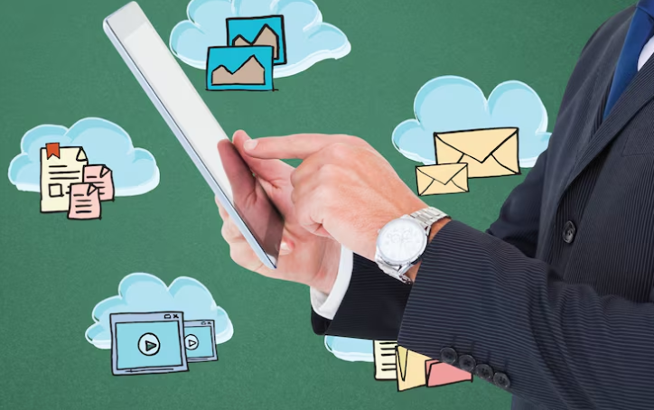 Businessman using tablet with email and cloud storage icons.