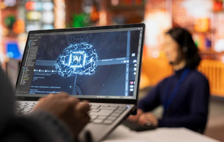 Person using laptop with digital brain graphic representing artificial intelligence.