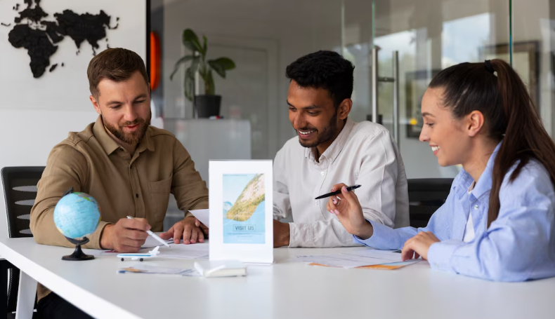Group of colleagues collaborating on documents around table with small globe.