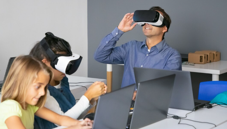 Classroom with kids and teacher using VR headsets for learning