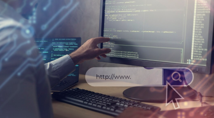 A developer coding on a desktop computer.