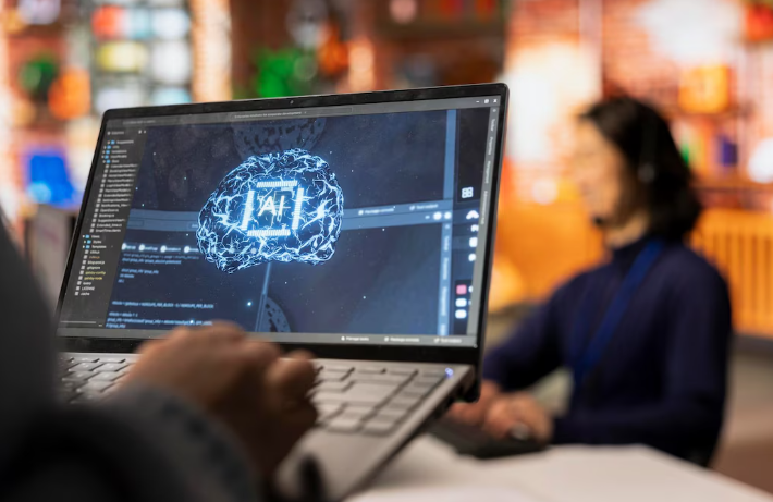 Laptop screen showing AI brain visualization with coding environment.