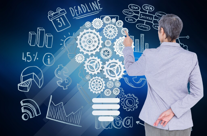 Business professional analyzing innovation strategy with illustrated lightbulb and charts.