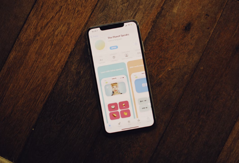 Smartphone displaying app interface on wood