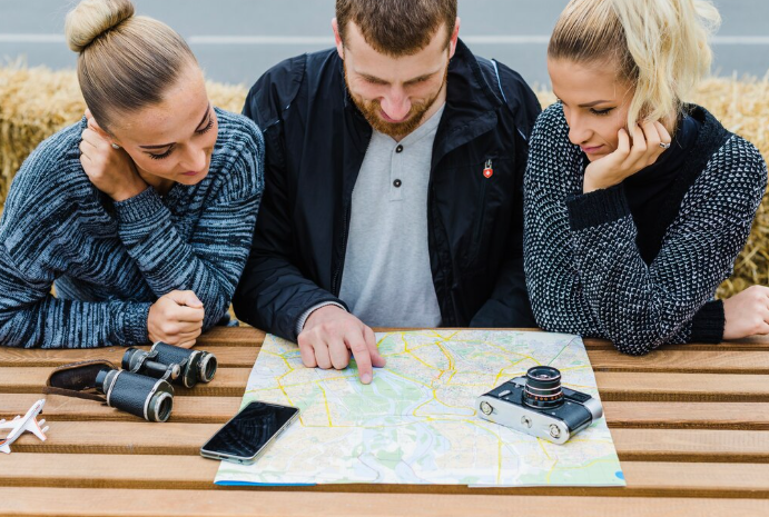 Three people examining a map.