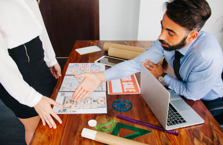 Business meeting with architectural plans.