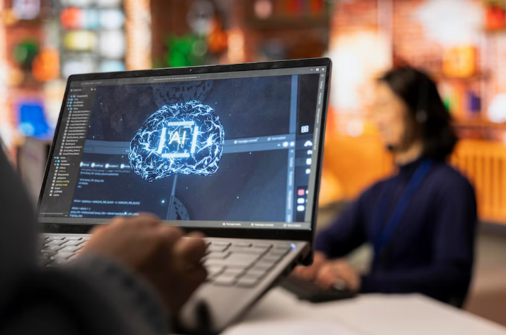 Person holding laptop displaying AI brain interface design.
