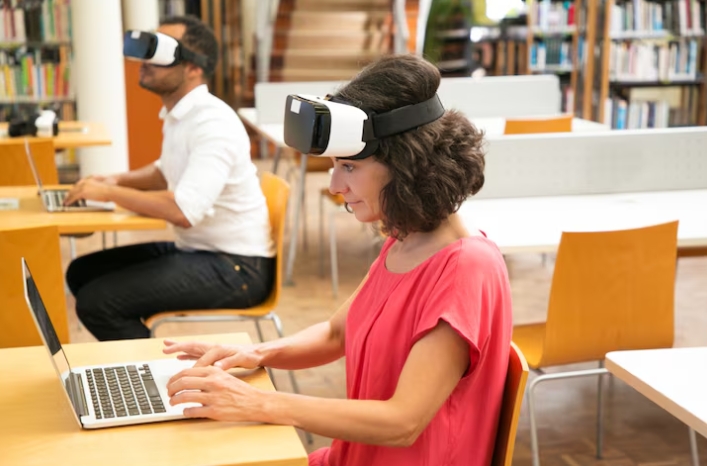 Alt text: People using VR headsets while working on laptops.