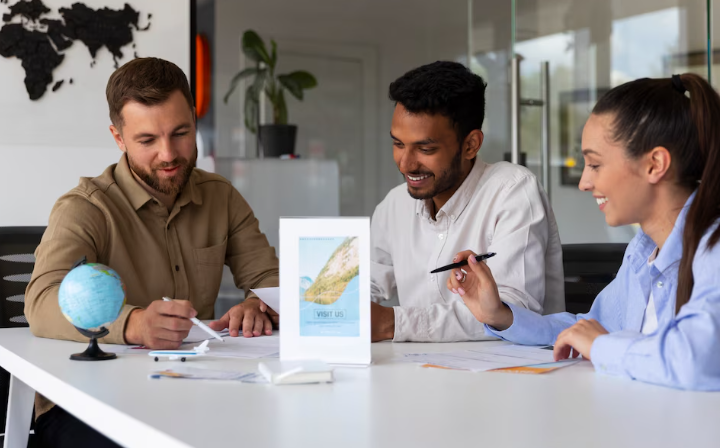 Three colleagues planning a trip with maps and documents