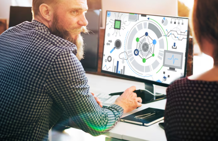 Man working on computer with automation flowchart on screen