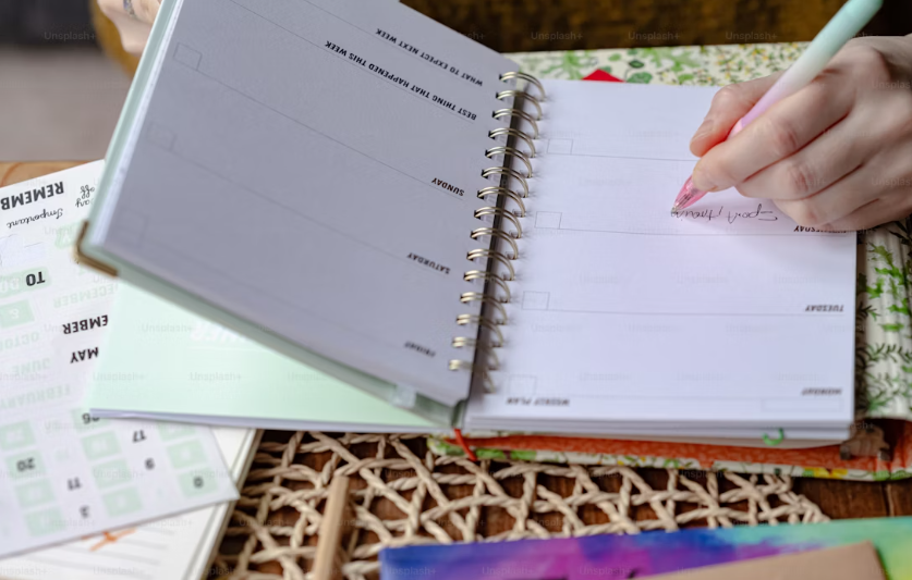 Person writing in a planner