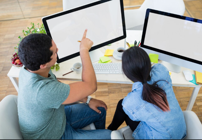 Two people discussing at a desk