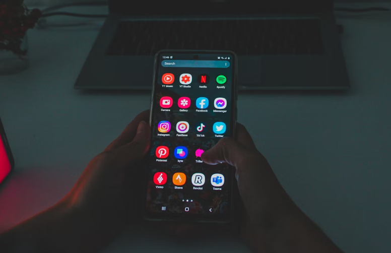 Person holding smartphone with apps