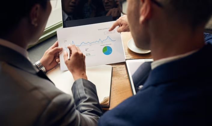 Business professionals analyzing data charts and performance graphs.