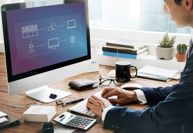 Businessman working on desktop computer with cloud computing diagram screen.