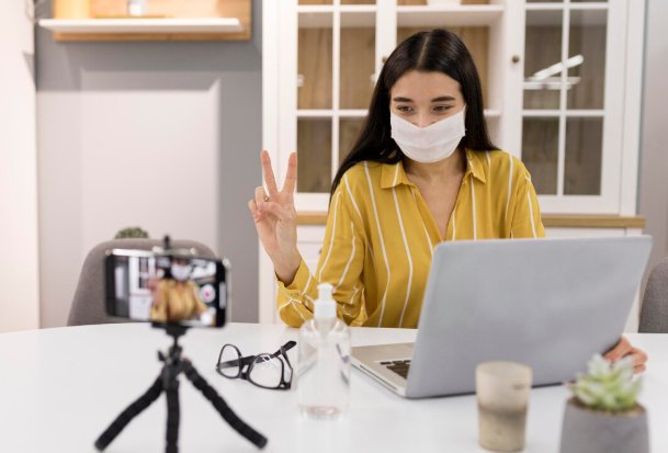 Person on video call with laptop.