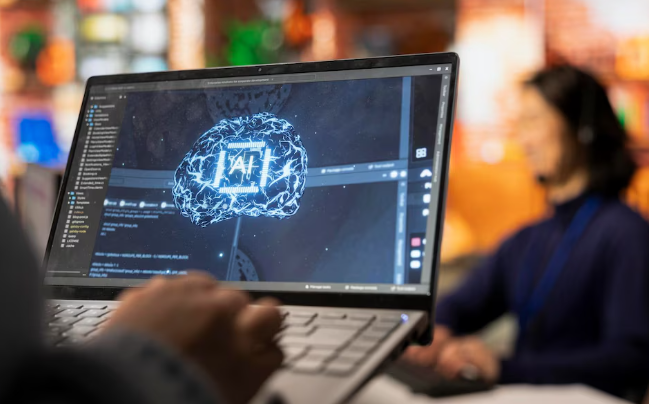 Person using laptop showing artificial intelligence holographic brain design.