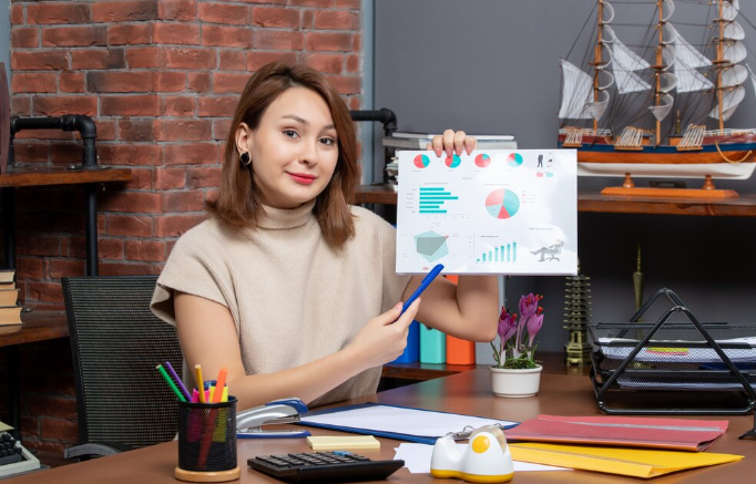 Woman presenting colorful data charts and graphs in modern office.