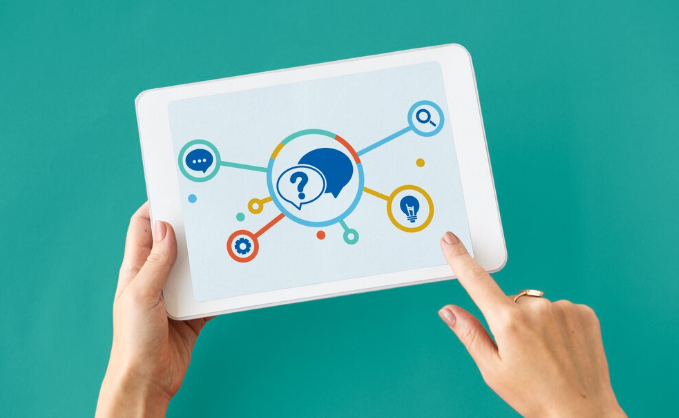 Hands holding tablet showing colorful digital knowledge network diagram.
