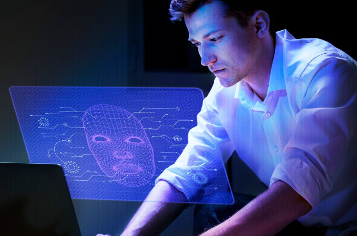 Man analyzing holographic 3D facial recognition projection on his laptop.