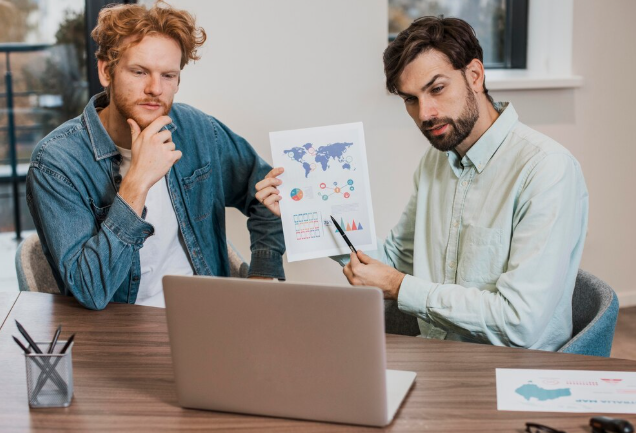 Two men analyzing world map data and business growth.