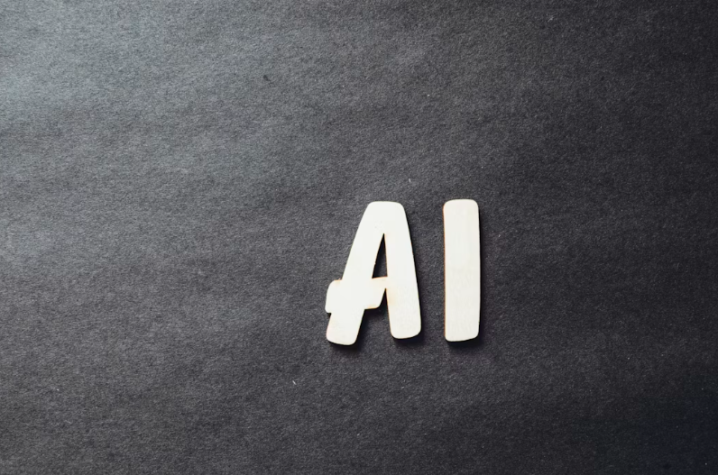 Wooden AI letters placed on a dark textured black background.