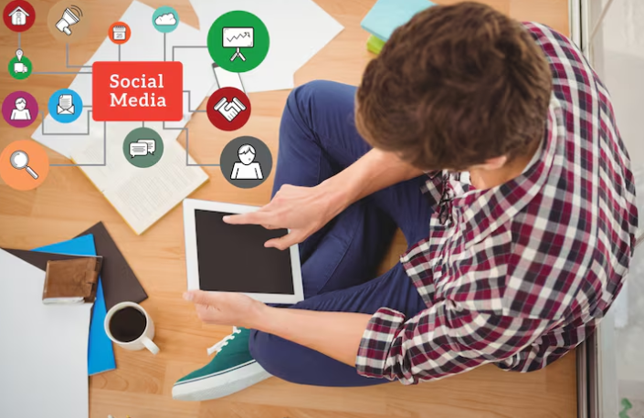 Man using tablet with social media network icons around.