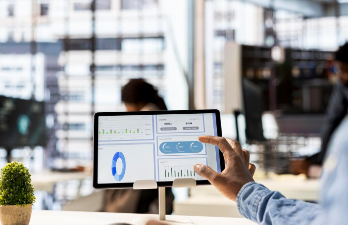 Person analyzing financial data charts on a digital tablet screen.