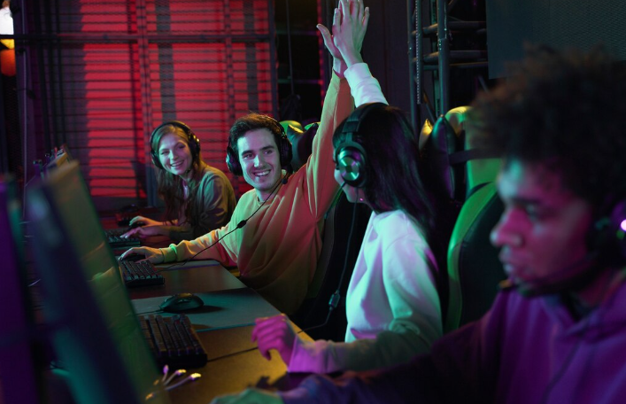 Gamers in a team celebrating a win with high five and won a hackathon with a no-code app