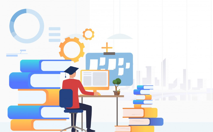 Graduate student studying online at desk surrounded by books.