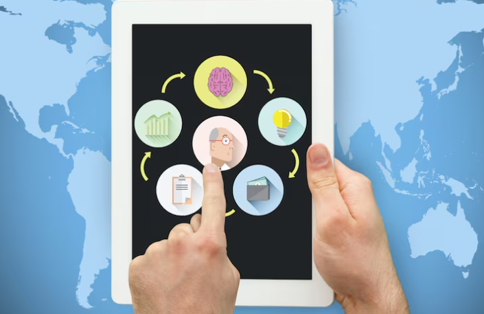 Hands holding tablet displaying icons for business strategy and ideas and