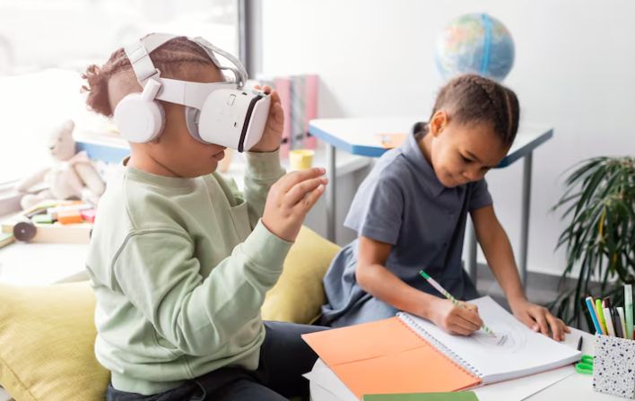 Child using VR headset while another draws in notebook.