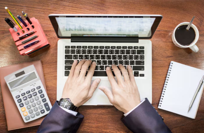 Person typing on laptop at desk and doing for Accounting Automation.
