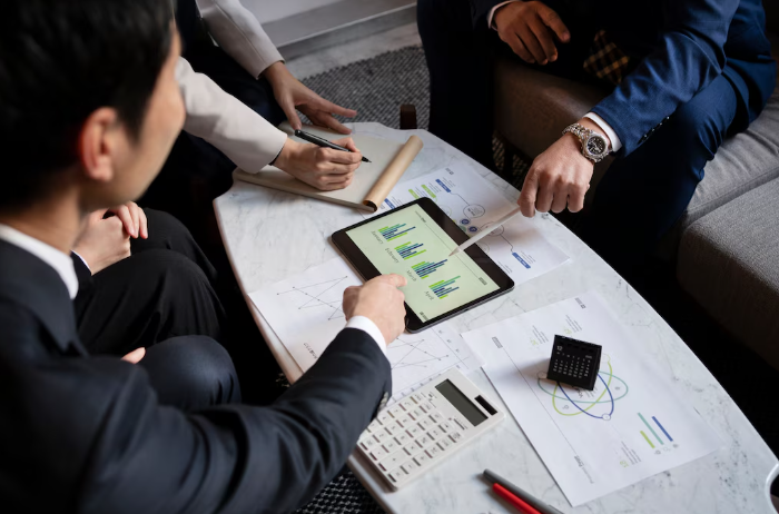 Business meeting with charts and documents.