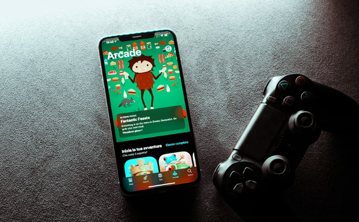 Phone displaying game app next to controller