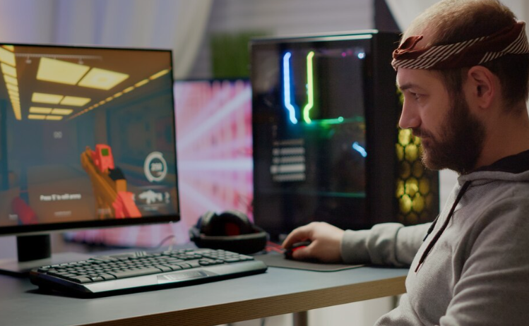 Person gaming with computer setup.