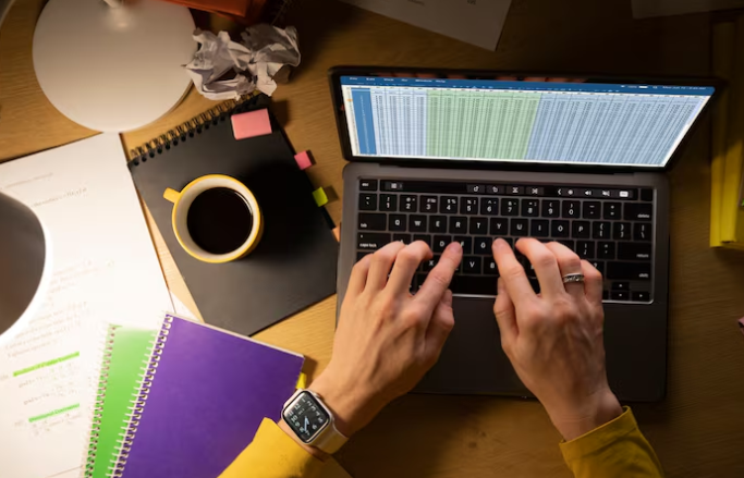 Person typing on laptop with coffee