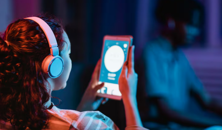 Person enjoying music on tablet.