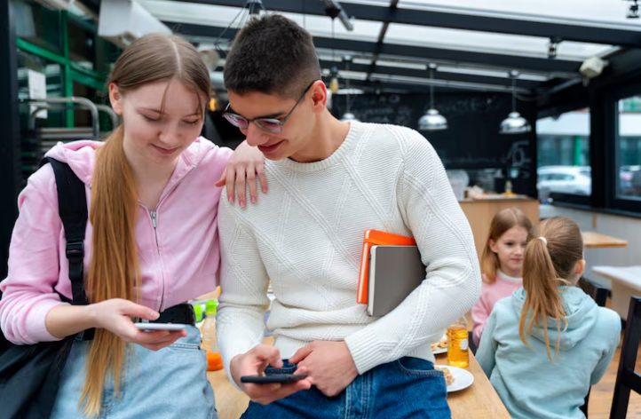 Two people engaging with their smartphones in a casual setting.