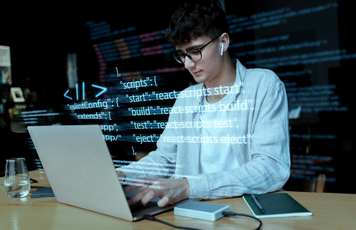 Young developer coding with projected programming scripts.